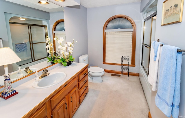 full bathroom featuring shower / bath combination with glass door, vanity, and toilet