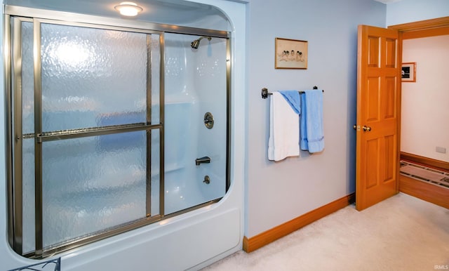 bathroom with bath / shower combo with glass door