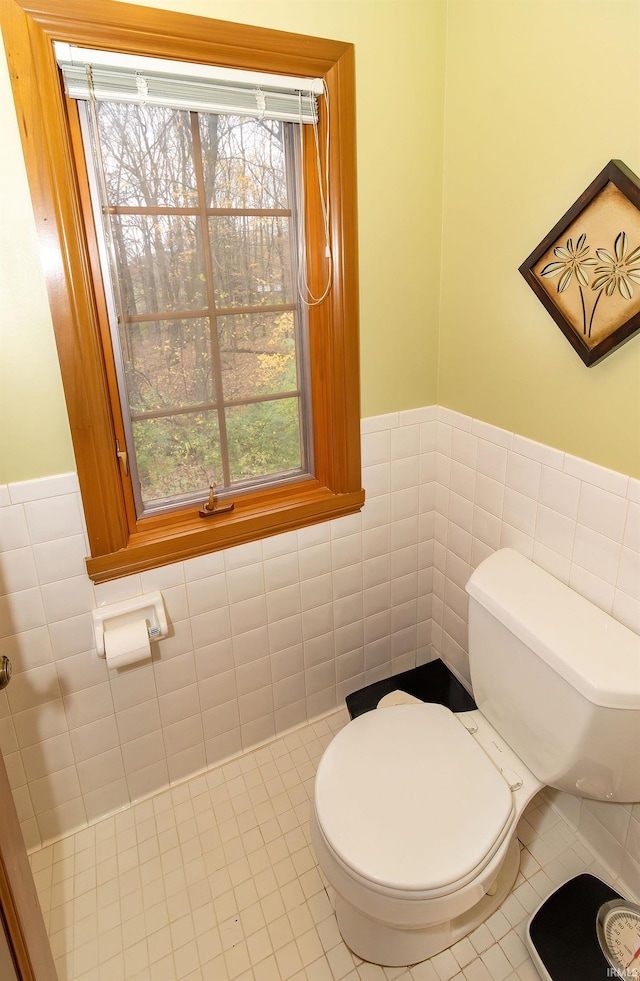 bathroom with tile patterned floors, tile walls, and toilet