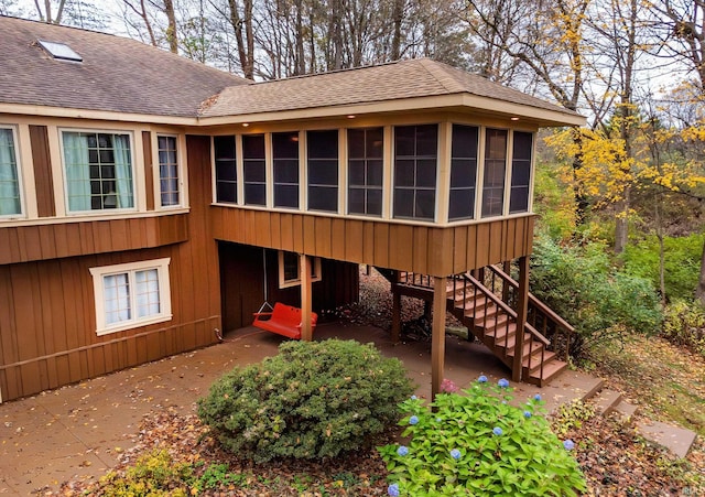 rear view of house featuring a patio and a sunroom