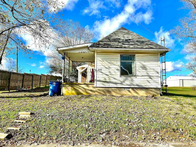 back of property featuring a lawn