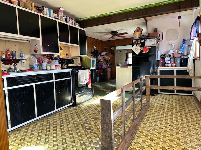 kitchen with ceiling fan, range with electric stovetop, and wooden walls