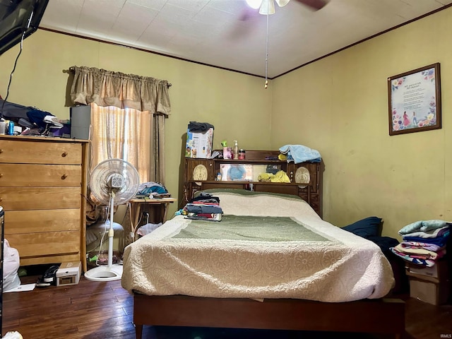 bedroom with ceiling fan, wood-type flooring, and ornamental molding