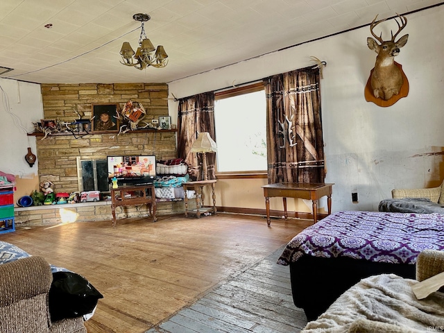 bedroom with hardwood / wood-style floors and a chandelier