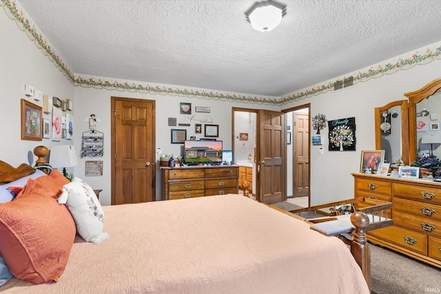 bedroom featuring carpet and a textured ceiling