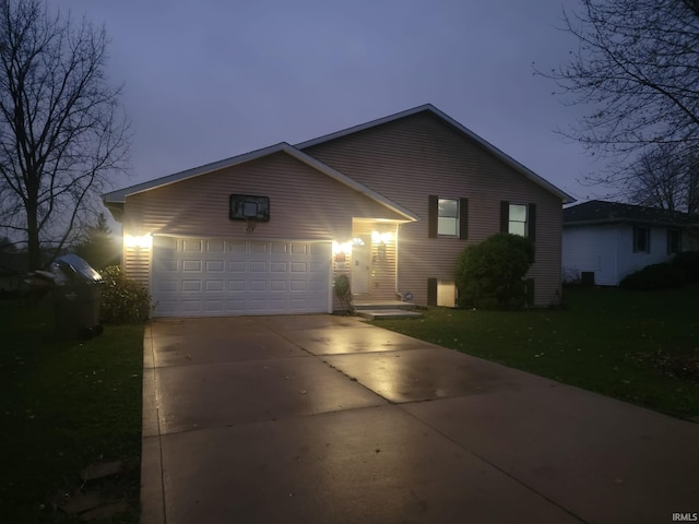 ranch-style house with a yard and a garage