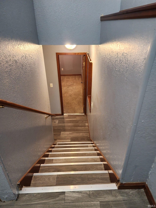 stairs with hardwood / wood-style flooring