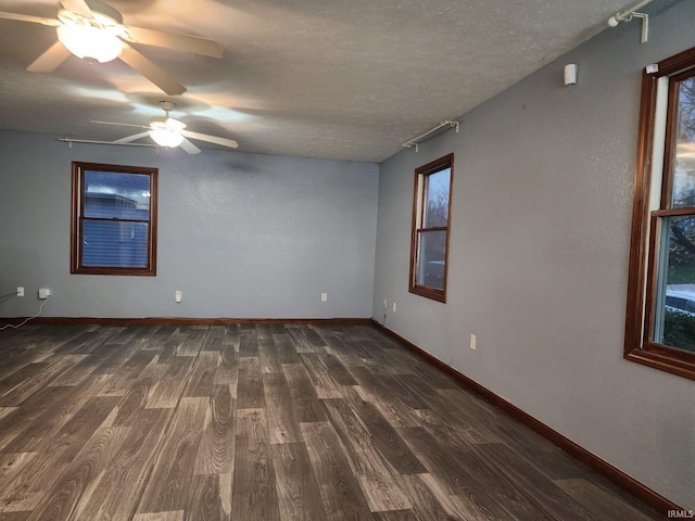 spare room featuring a textured ceiling, dark hardwood / wood-style floors, and ceiling fan