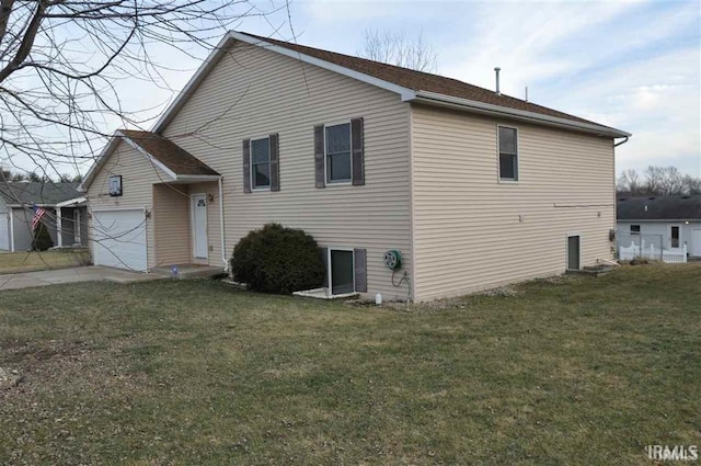 view of side of home with a lawn and a garage