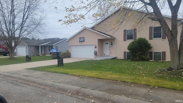 tri-level home with a garage and a front yard