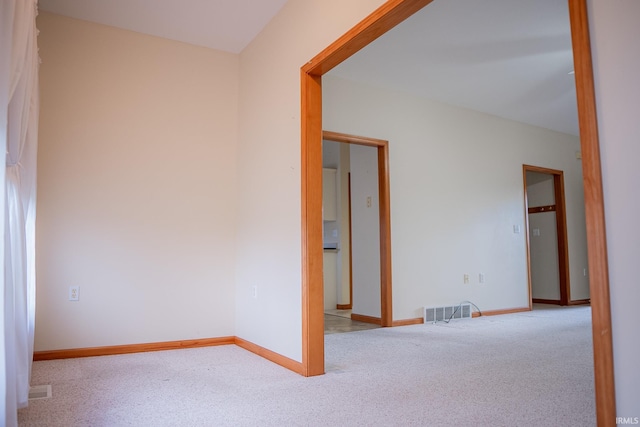 spare room featuring light colored carpet