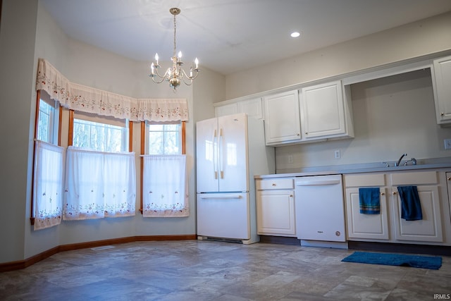 kitchen with white cabinets, a notable chandelier, white appliances, and hanging light fixtures