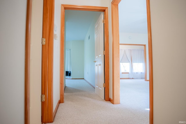 hall featuring light colored carpet