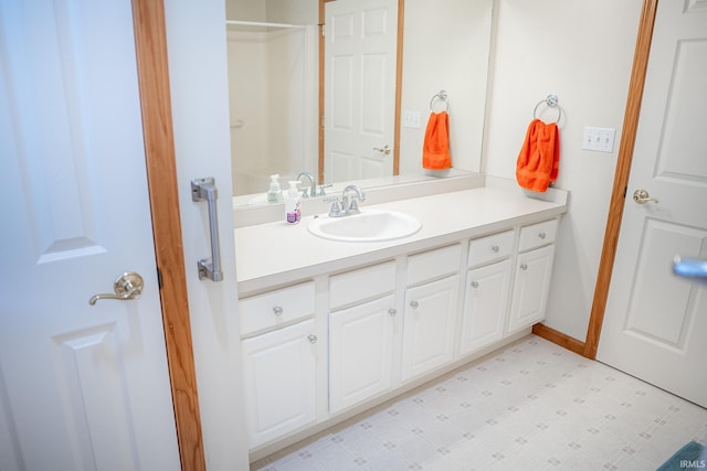 bathroom featuring a shower and vanity