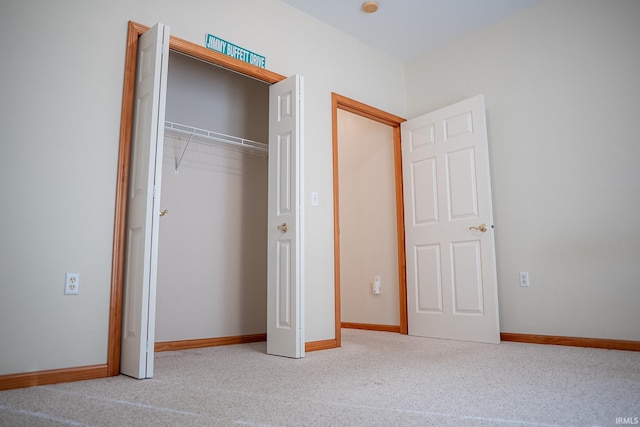 unfurnished bedroom featuring carpet and a closet