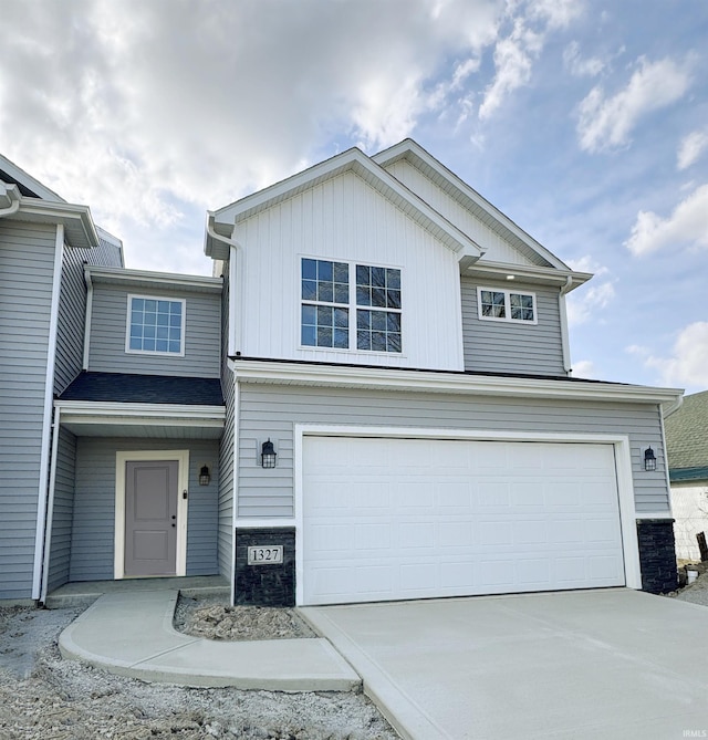 1327 W Hamilton N Rd, Fort Wayne, IN 46814 - view of front of property featuring a garage, driveway, and stone siding