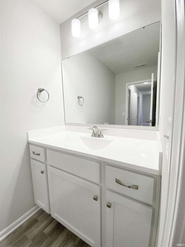 1327 W Hamilton N Rd, Fort Wayne, IN 46814 - bathroom featuring vanity, wood finished floors, and baseboards