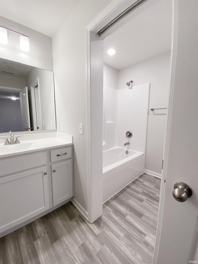 1327 W Hamilton N Rd, Fort Wayne, IN 46814 - bathroom with vanity, wood finished floors, shower / washtub combination, and baseboards