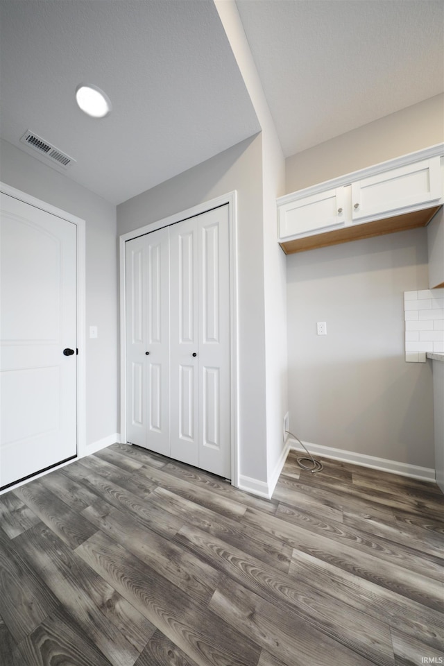 1327 W Hamilton N Rd, Fort Wayne, IN 46814 - unfurnished bedroom with baseboards, a closet, and dark wood-type flooring