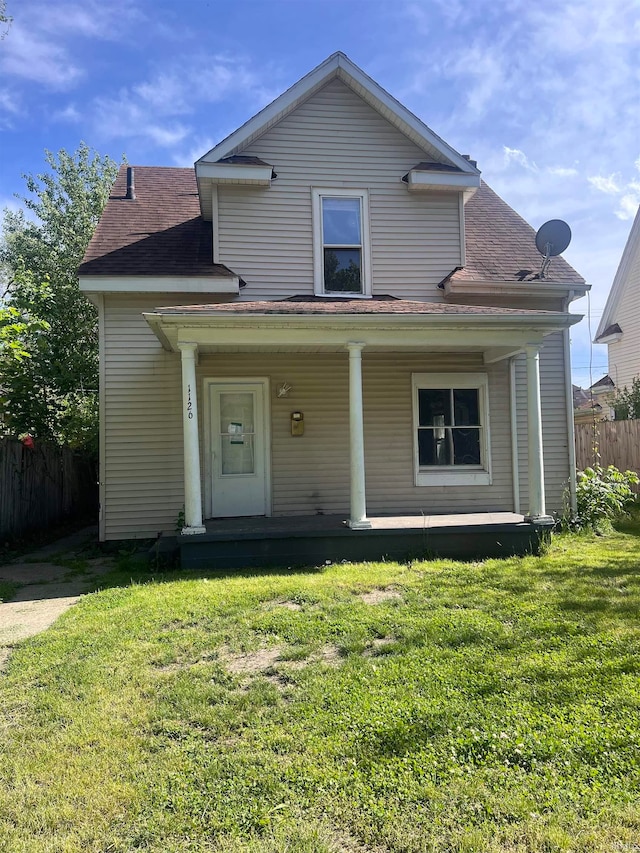 view of front facade featuring a front lawn and covered porch