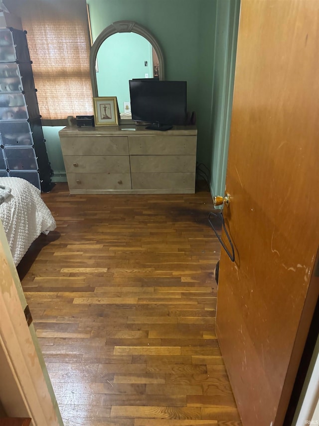 bedroom with dark wood-type flooring