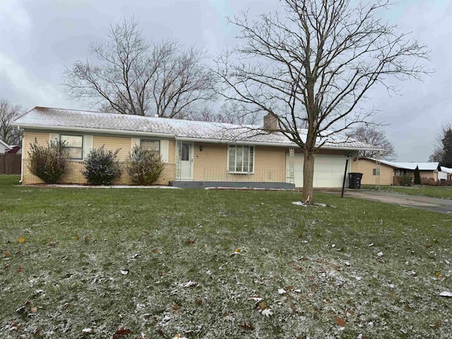 ranch-style house featuring a garage and a front lawn