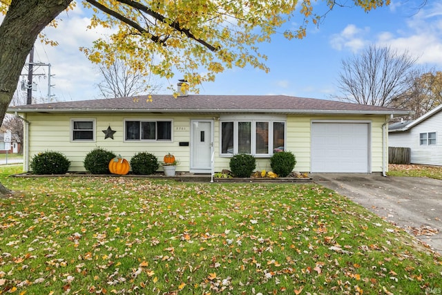 ranch-style house featuring a garage and a front yard