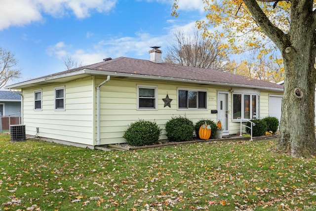 rear view of house featuring a yard and central AC unit