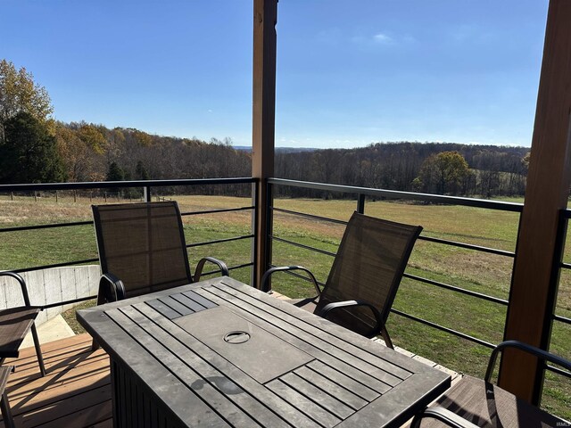 3536 Ridge Rd, Williams, IN 47470 - wooden terrace featuring a view of trees, a lawn, and outdoor dining area
