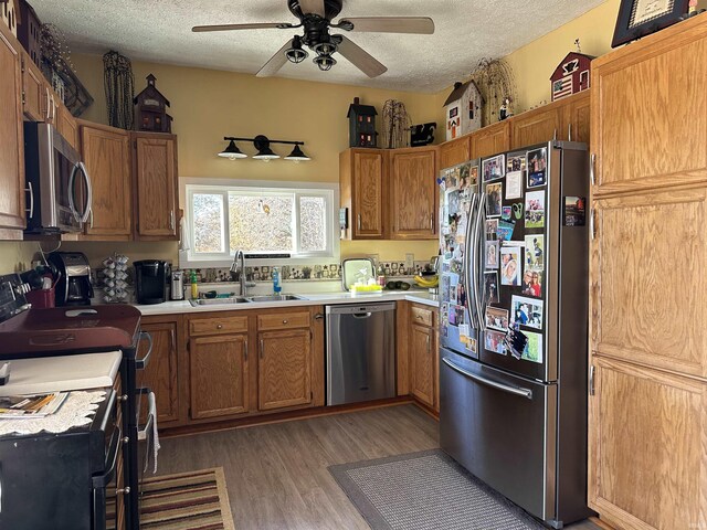 3536 Ridge Rd, Williams, IN 47470 - kitchen with stainless steel appliances, a sink, a textured ceiling, a ceiling fan, and light countertops
