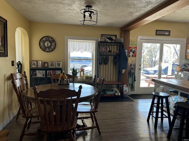 3536 Ridge Rd, Williams, IN 47470 - dining room with arched walkways, a textured ceiling, dark wood-type flooring, and baseboards