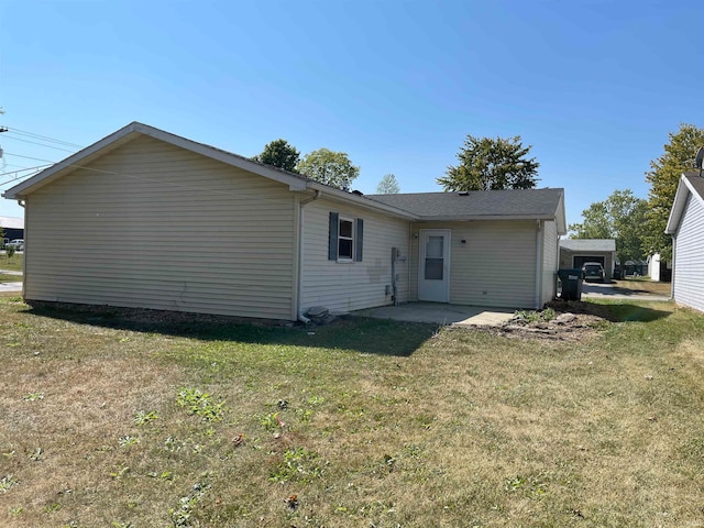 rear view of house with a yard and a patio