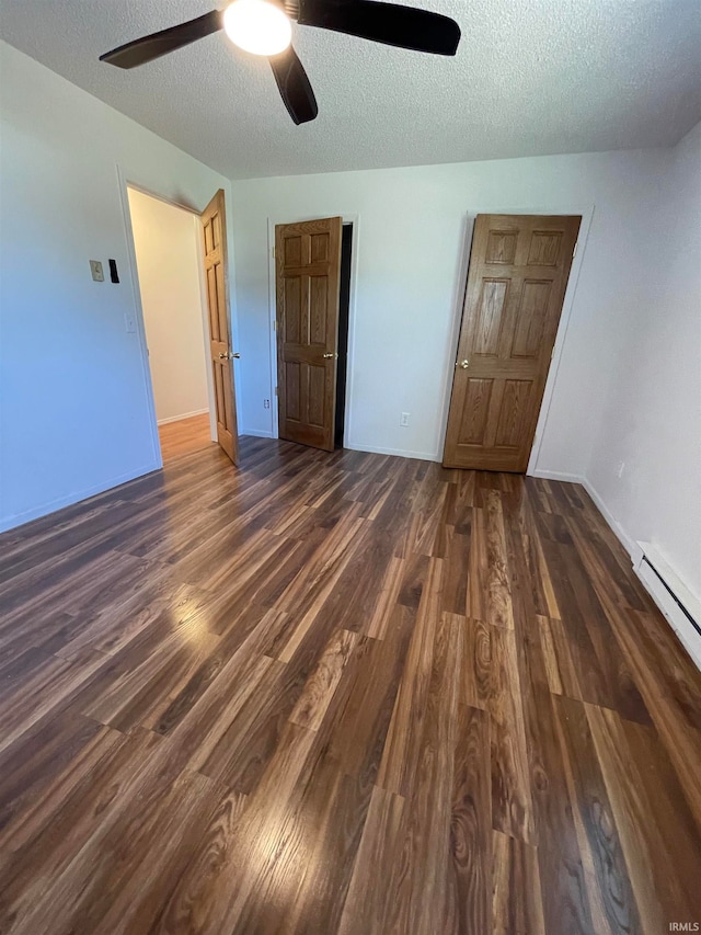 unfurnished bedroom featuring dark hardwood / wood-style floors, ceiling fan, and a textured ceiling