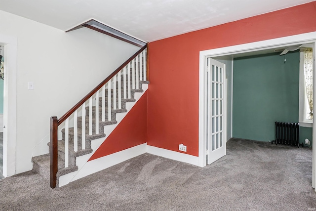 staircase with carpet floors and radiator