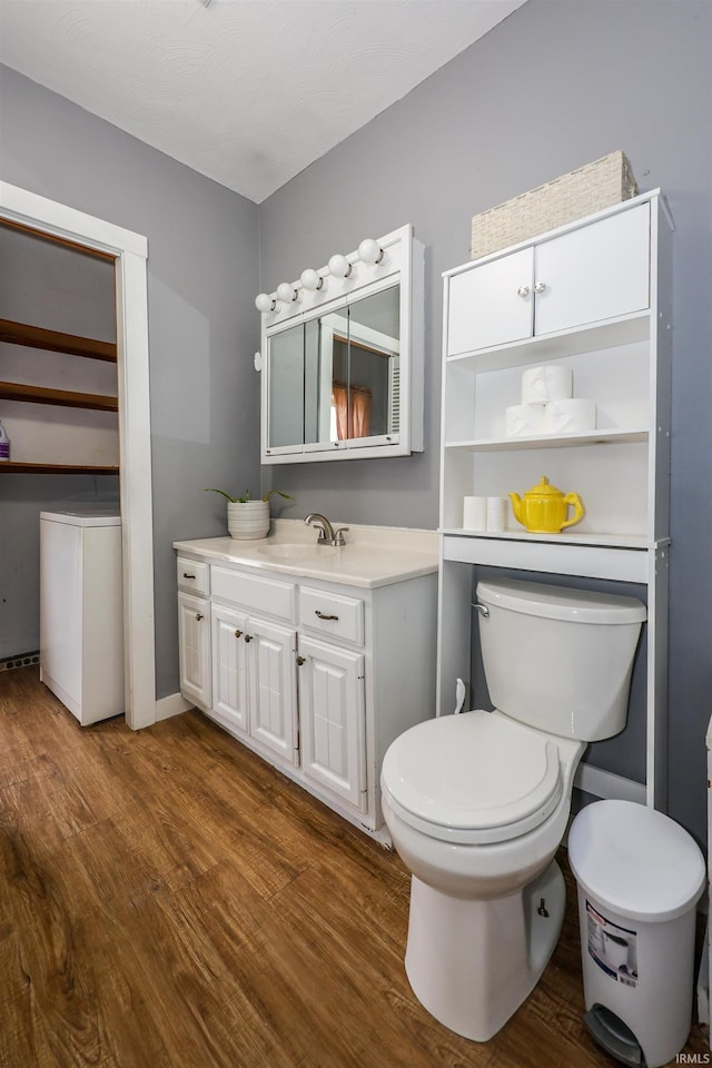 bathroom featuring hardwood / wood-style floors, vanity, and toilet