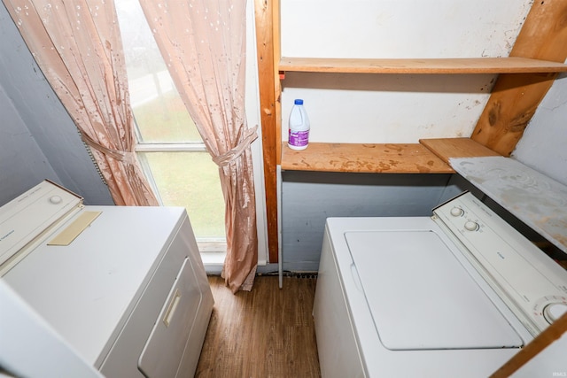 laundry area featuring independent washer and dryer, a wealth of natural light, and wood-type flooring