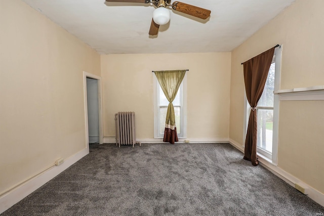 unfurnished room featuring radiator, ceiling fan, and carpet