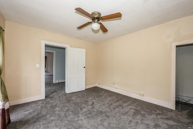 carpeted empty room featuring baseboard heating and ceiling fan