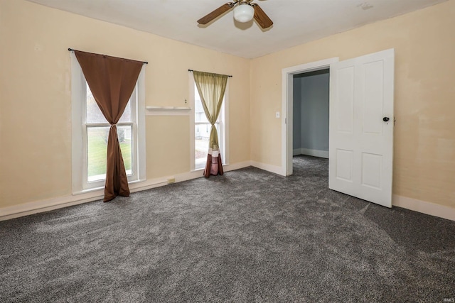 carpeted empty room featuring ceiling fan