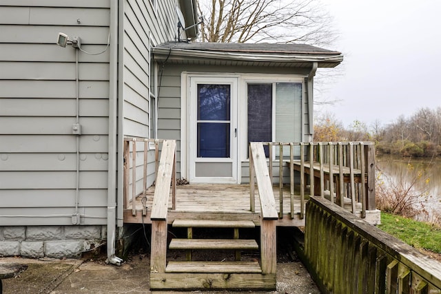 view of exterior entry with a wooden deck