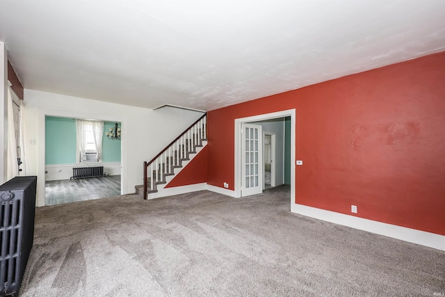 carpeted spare room with radiator heating unit