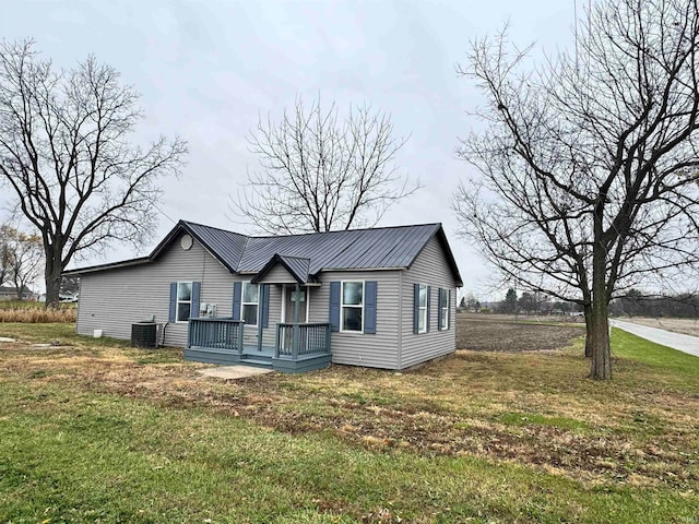 view of front of property featuring central AC and a front lawn