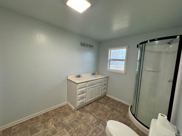 bathroom featuring vanity, toilet, and walk in shower