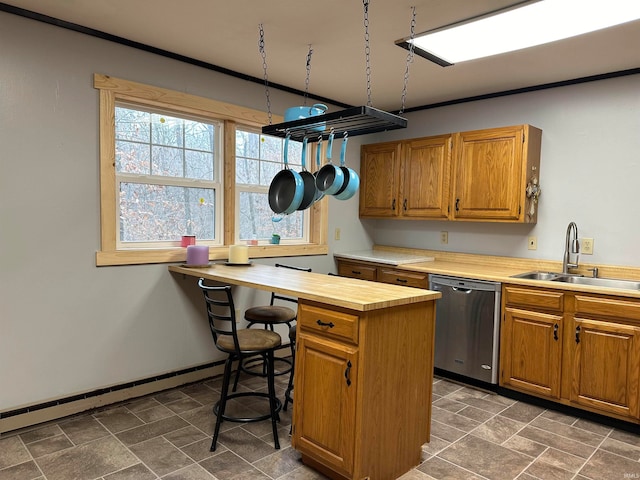 kitchen featuring butcher block countertops, stainless steel dishwasher, a baseboard radiator, and sink