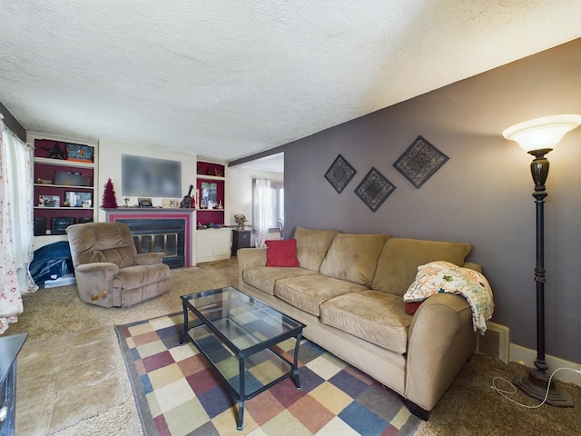 living room featuring a textured ceiling and carpet floors