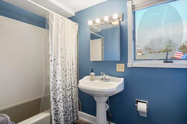 bathroom with shower / bath combo with shower curtain