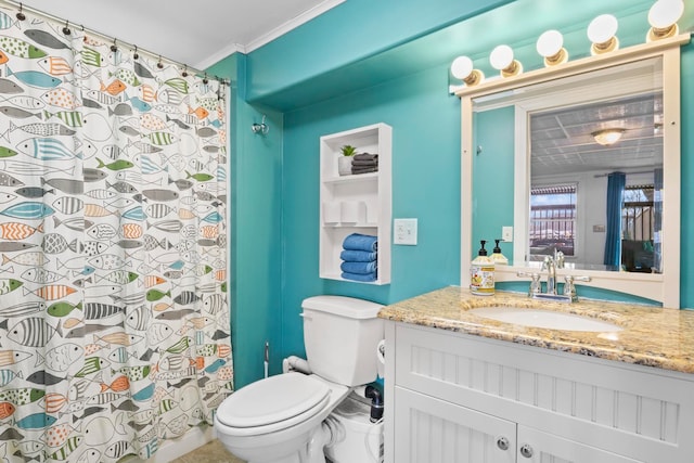 bathroom with crown molding, vanity, and toilet