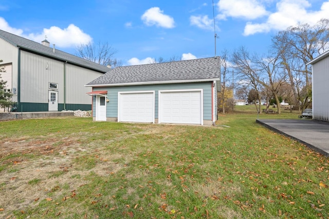 garage featuring a lawn