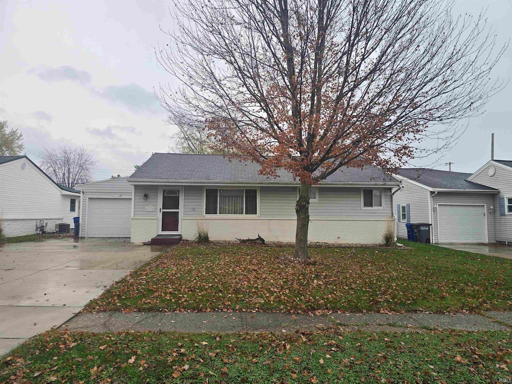 view of front of house with a front yard and a garage