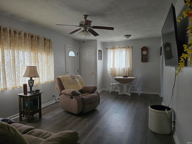 sitting room featuring a textured ceiling, ceiling fan, and dark hardwood / wood-style floors